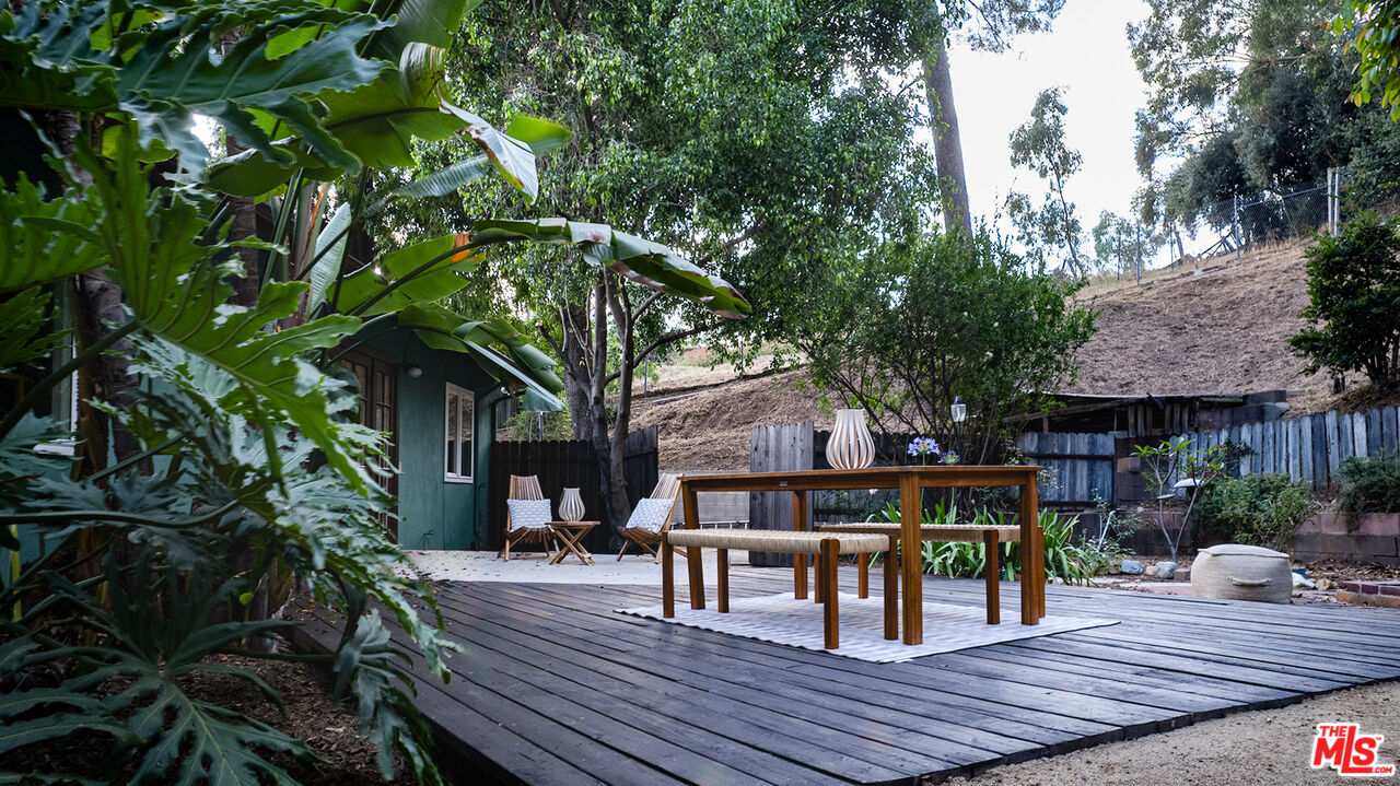 626 Oleander Drive Los Angeles, CA 90042 - Photo 59 of 75 a view of a dinning table and chairs in patio of the house