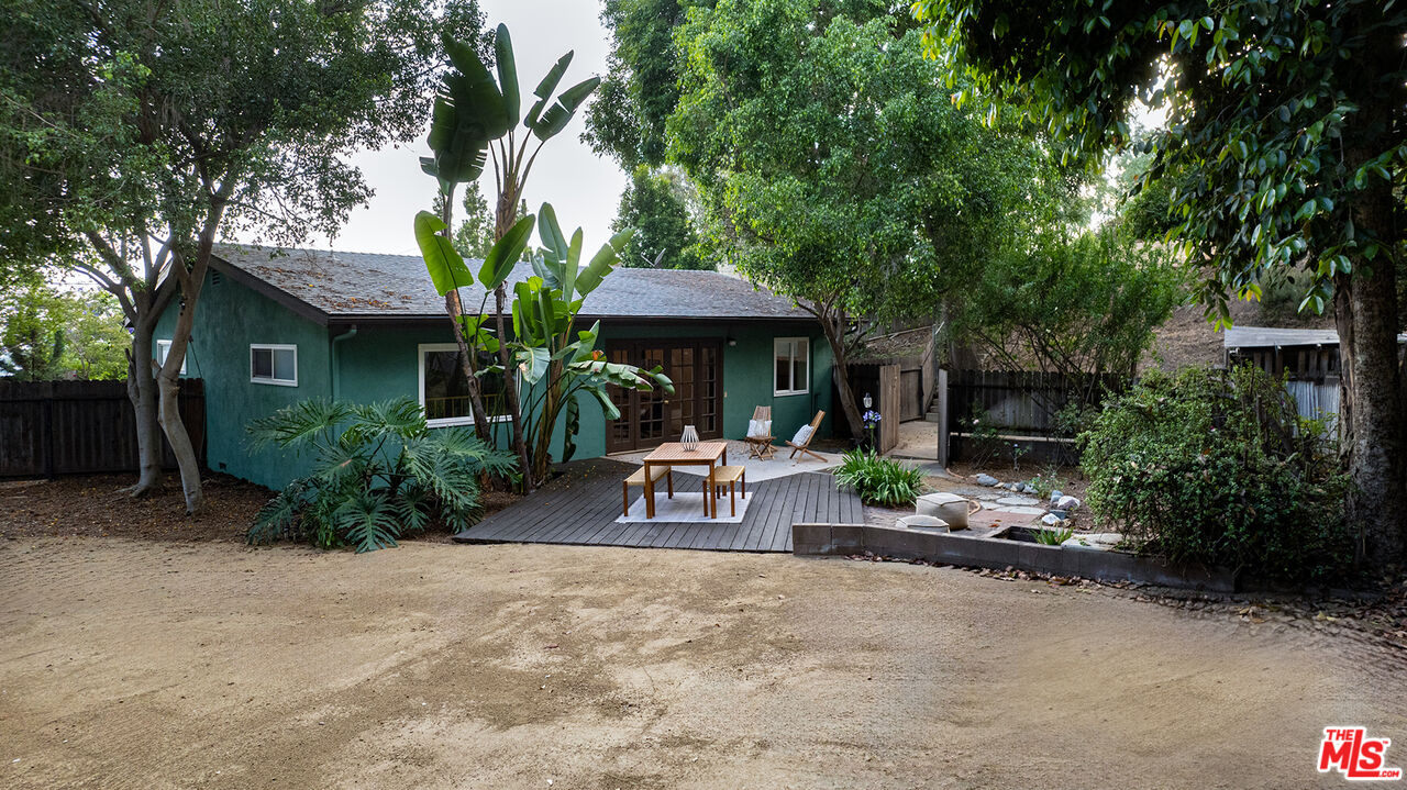 626 Oleander Drive Los Angeles, CA 90042 - Photo 60 of 75 a view of a patio with table and chairs potted plants and large tree