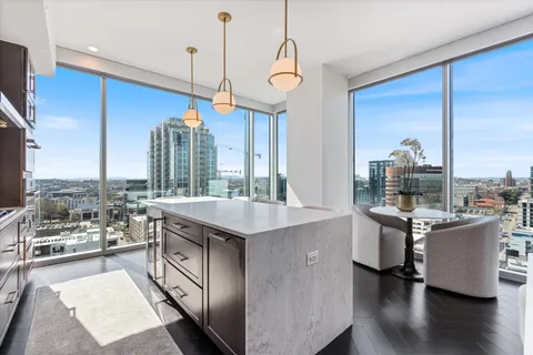 a kitchen with stainless steel appliances granite countertop a stove and a wooden floors