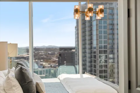 a large kitchen with kitchen island a island a sink a stove and a view of living room