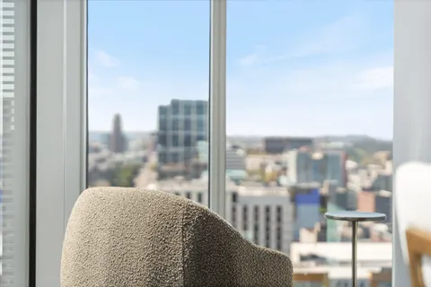 a view of a living room with a floor to ceiling window