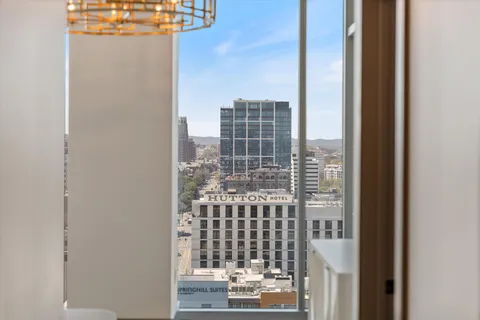 a bedroom with a bed a flat screen tv and balcony view