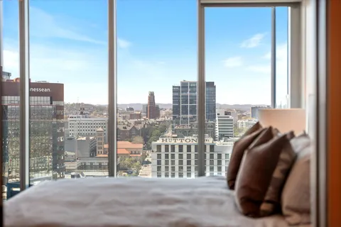 a bedroom with a bed and a chandelier