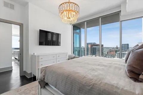 a large bed sitting in a bedroom next to a window