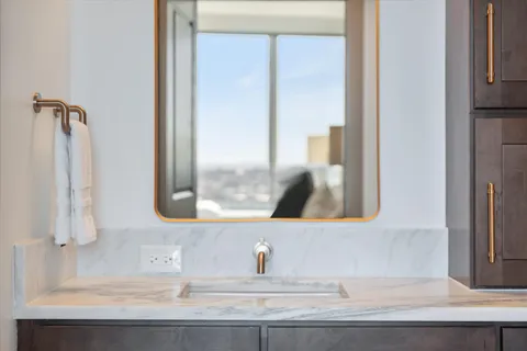 a very nice looking living room with a large window and dining table