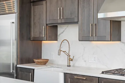 a living room with furniture ceiling fan and a large window