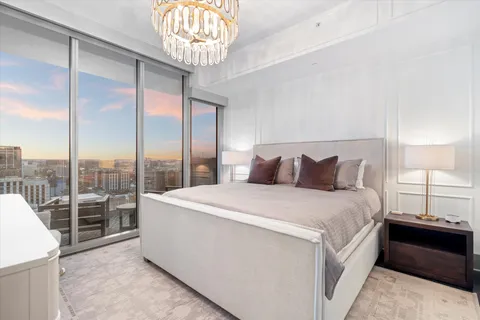 a view of a dining room with furniture large windows and wooden floor