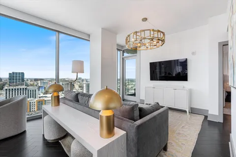 a bedroom with a bed and a flat tv screen on the dresser