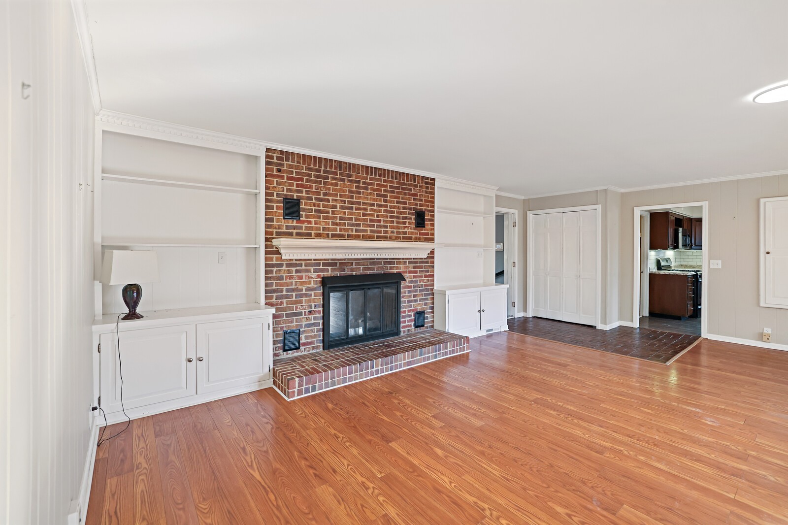 220 Hampton Road Columbia, TN 38401 - Photo 17 of 74 an empty room with wooden floor fireplace and windows
