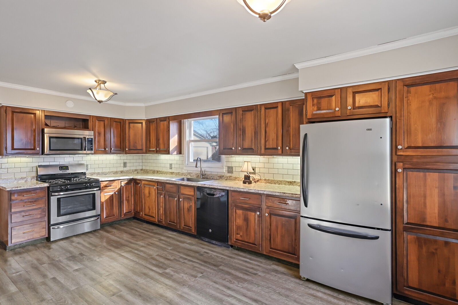 220 Hampton Road Columbia, TN 38401 - Photo 22 of 74 a kitchen with granite countertop stainless steel appliances and wooden cabinets