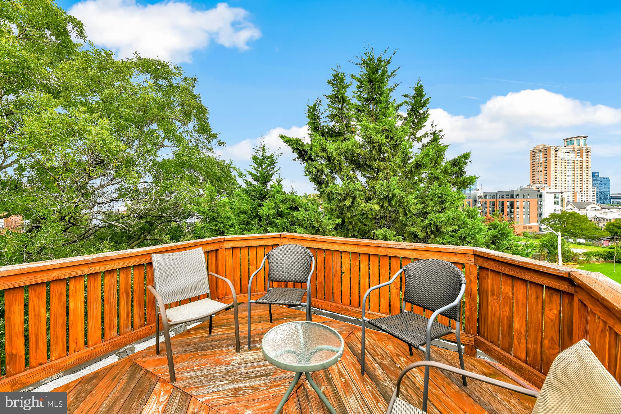 1257 Riverside Avenue, Unit D Baltimore, MD 21230 - Photo 24 of 36 a view of a patio with table and chairs with wooden floor and fence