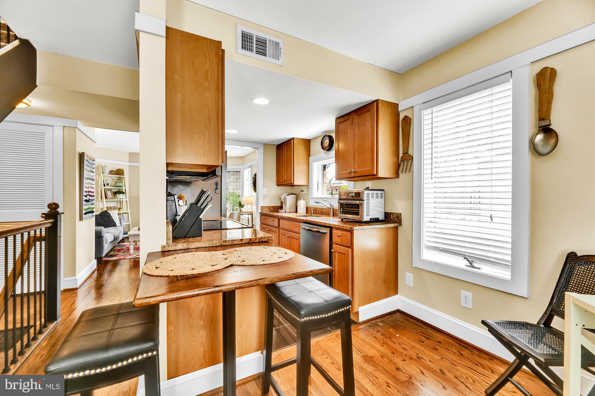 1257 Riverside Avenue, Unit D Baltimore, MD 21230 - Photo 8 of 36 a kitchen with a table chairs refrigerator and cabinets