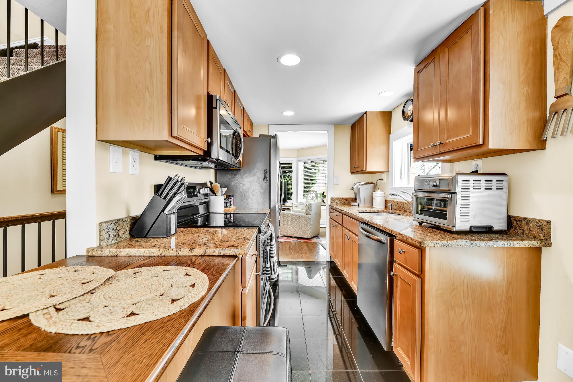 1257 Riverside Avenue, Unit D Baltimore, MD 21230 - Photo 9 of 36 a kitchen with stainless steel appliances granite countertop a sink a stove and a refrigerator