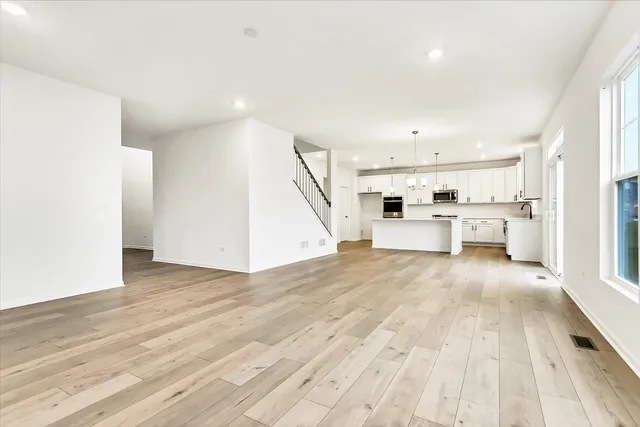 a view of a kitchen with furniture and wooden floor