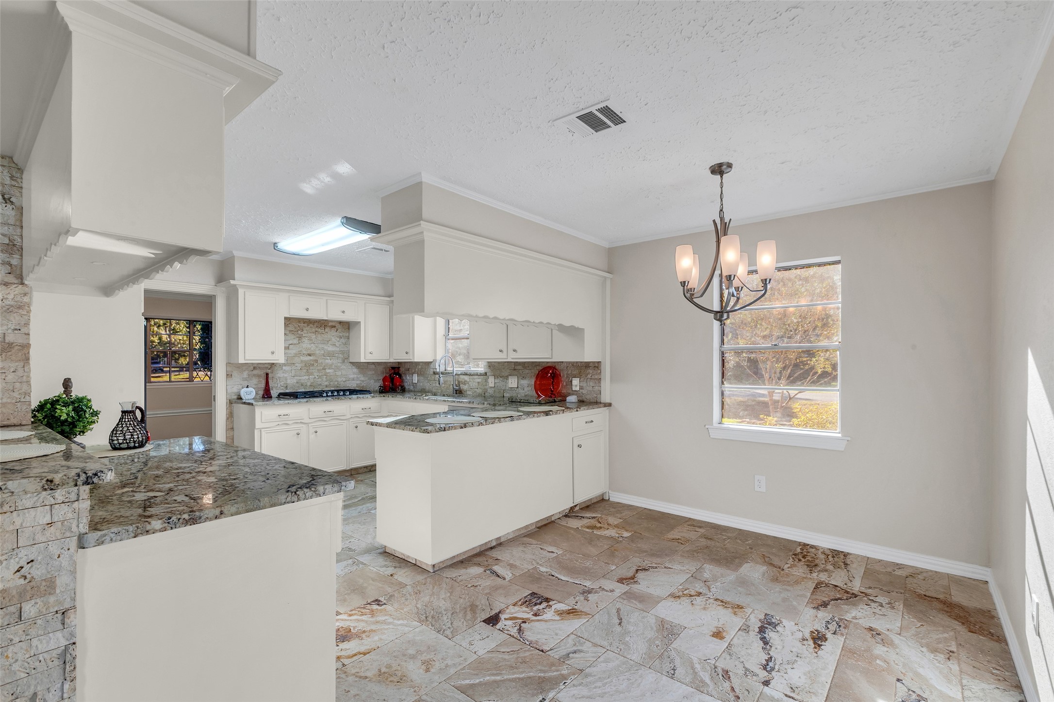 603 St Andrews Road Kingwood, TX 77339 - Photo 16 of 34 a large kitchen with kitchen island stainless steel appliances a stove a sink dishwasher and a wooden cabinets