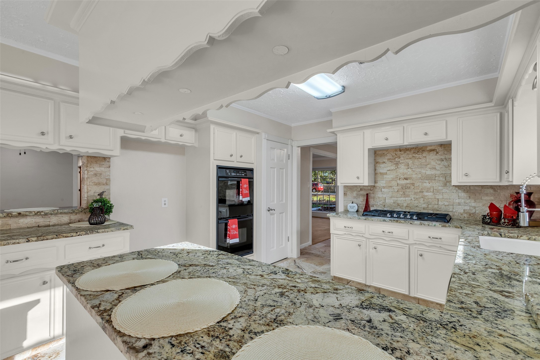 603 St Andrews Road Kingwood, TX 77339 - Photo 17 of 34 a kitchen with granite countertop a sink a stove and a wooden floor