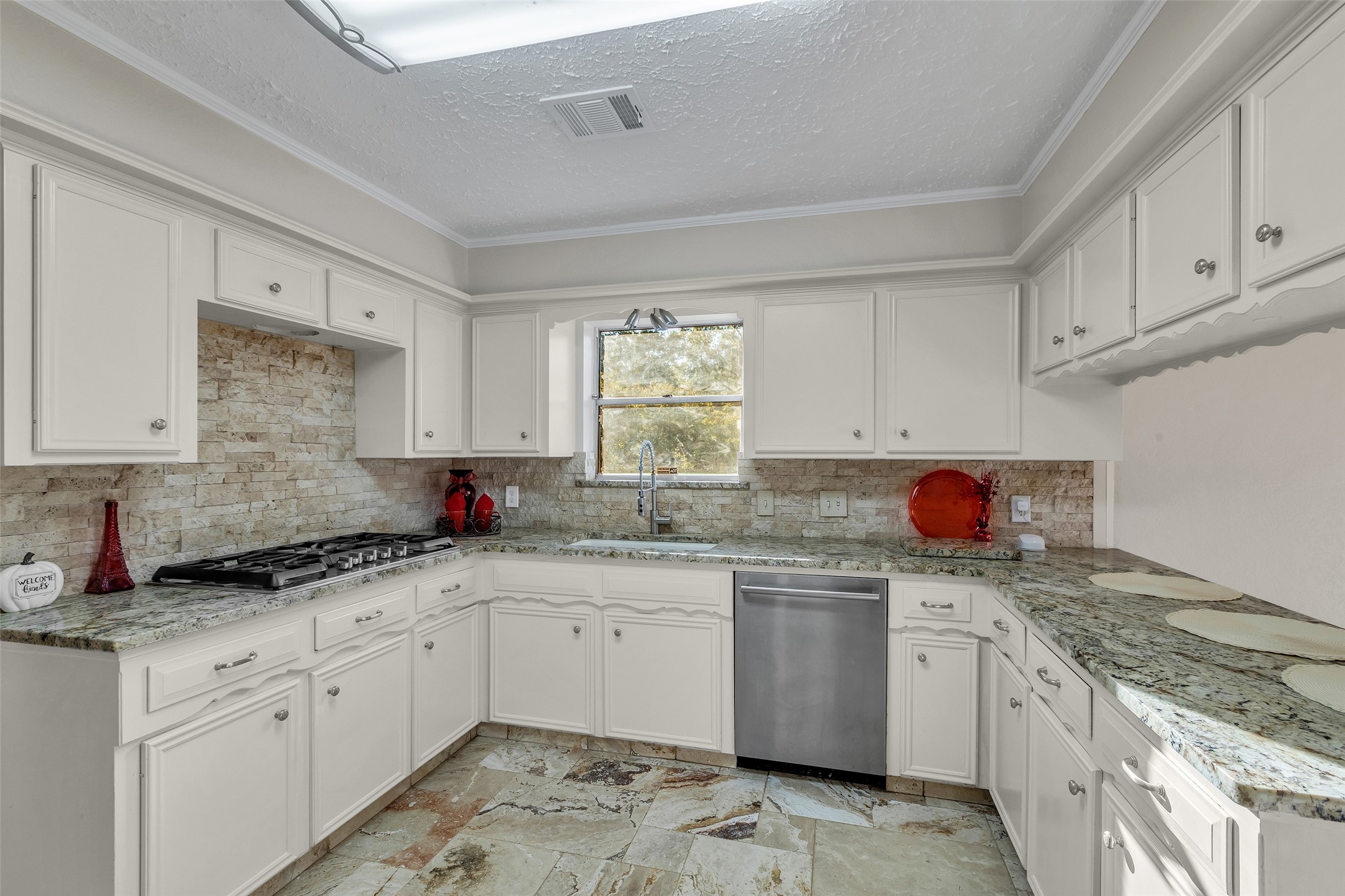 603 St Andrews Road Kingwood, TX 77339 - Photo 5 of 34 a kitchen with granite countertop a sink a stove and cabinets