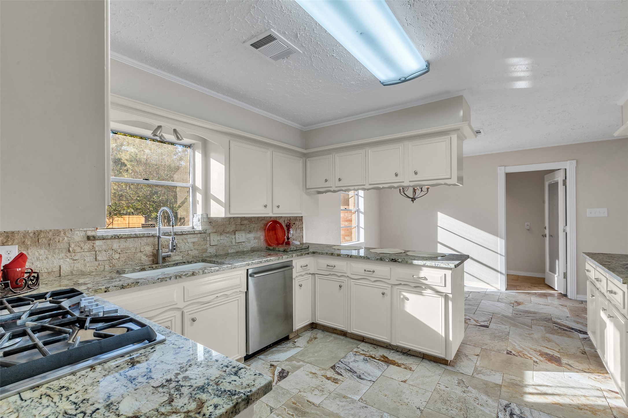 603 St Andrews Road Kingwood, TX 77339 - Photo 6 of 34 a kitchen with a sink appliances cabinets and a window