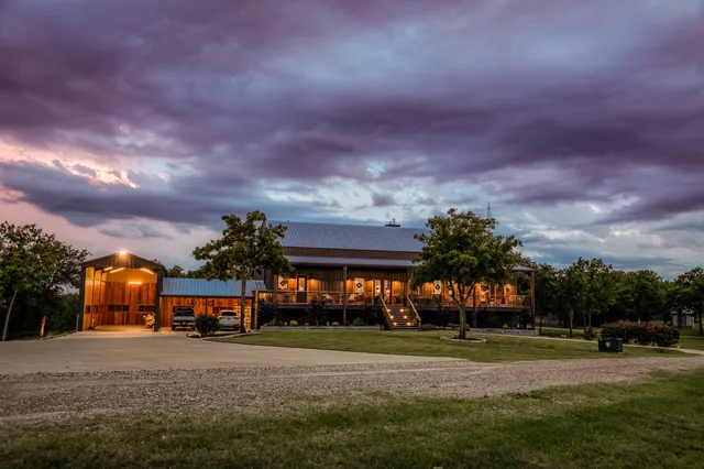 a front view of a house with a yard and a garage