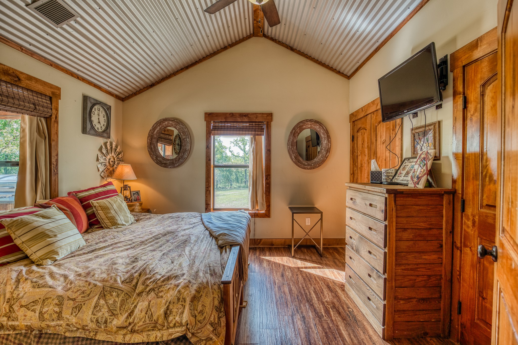 10092 County Road 446 Somerville, TX 77879 - Photo 34 of 50 a bedroom with a bed and dresser with wooden floor