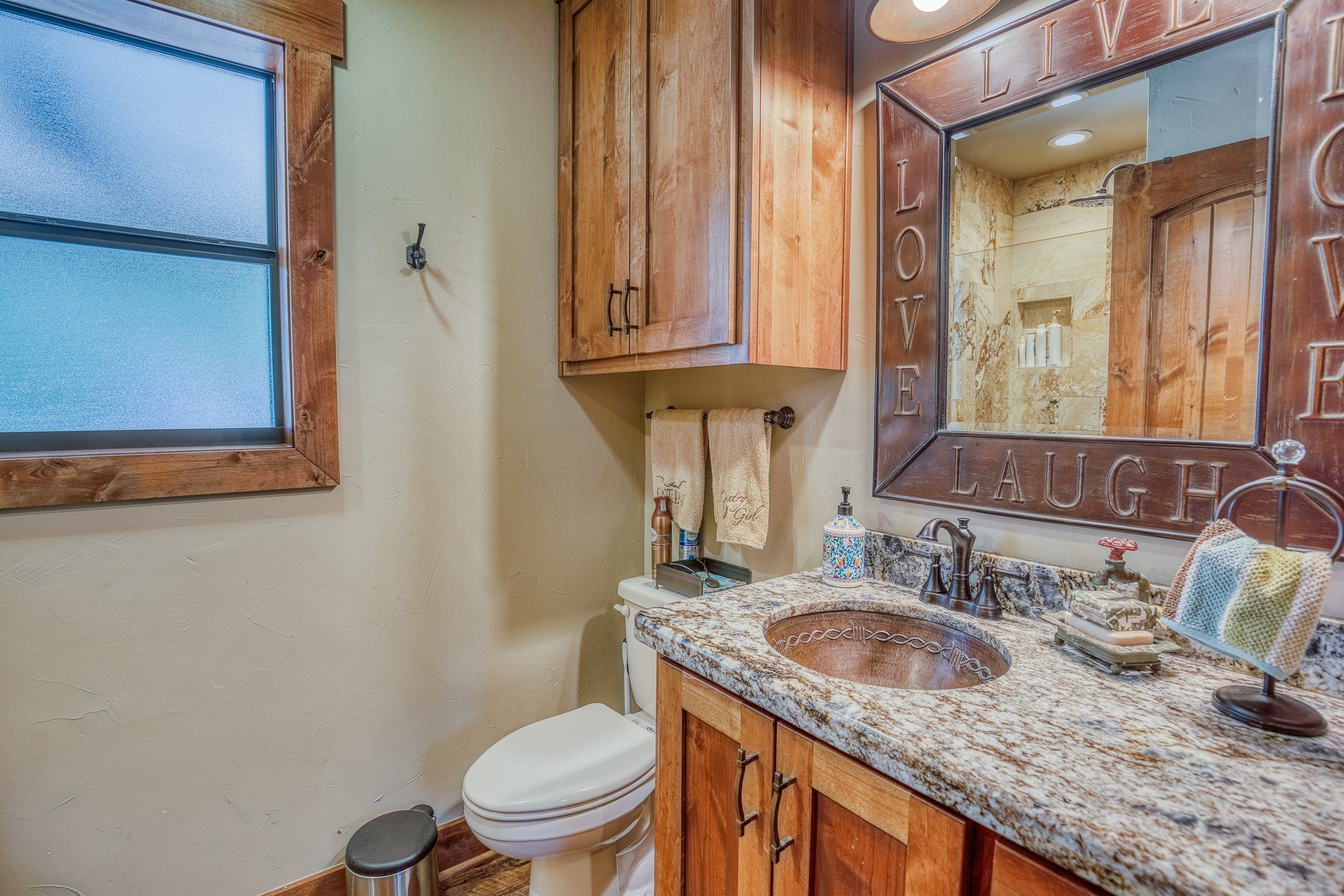 10092 County Road 446 Somerville, TX 77879 - Photo 36 of 50 a bathroom with a granite countertop toilet sink and mirror
