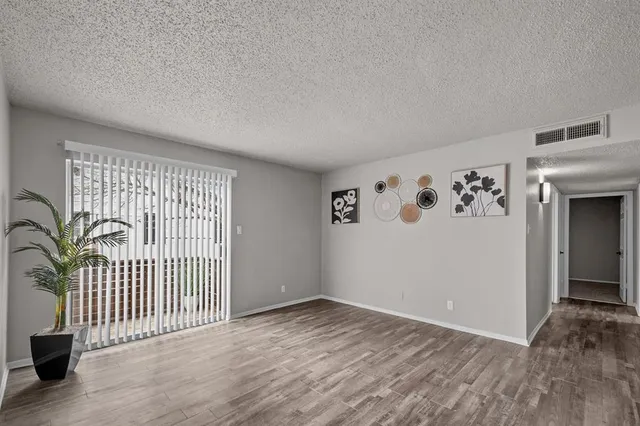 wooden floor in a hall with a window