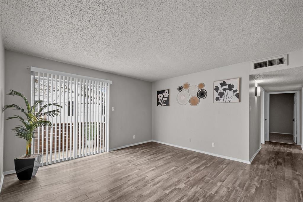 1300 East Dallas Street, Unit 2 Mansfield, TX 76063 - Photo 4 of 4 wooden floor in a hall with a window