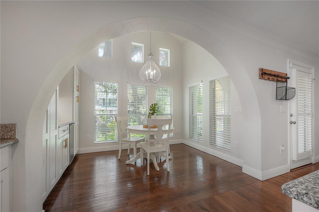 3108 West Villa Rosa Street Tampa, FL 33611 - Photo 11 of 58 a view of a dining room with furniture and wooden floor