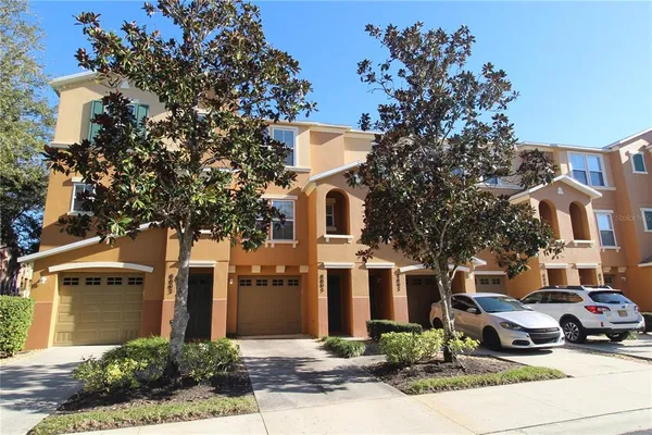 a car parked in front of a white house