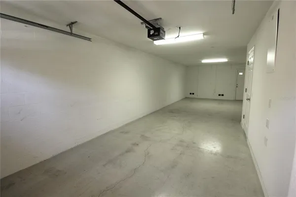 an empty room with a ceiling fan and shower