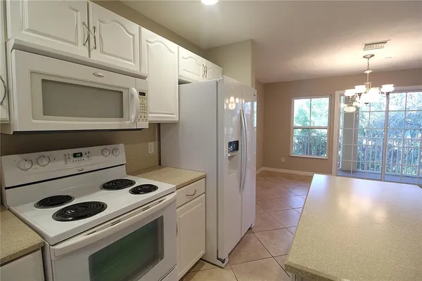 a kitchen with a stove and a refrigerator
