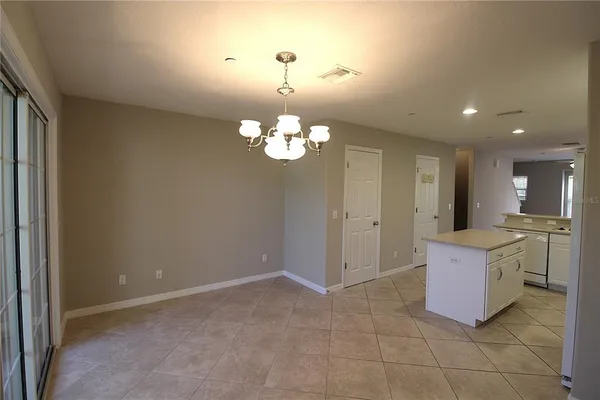 a spacious bathroom with a granite countertop sink a toilet and a mirror