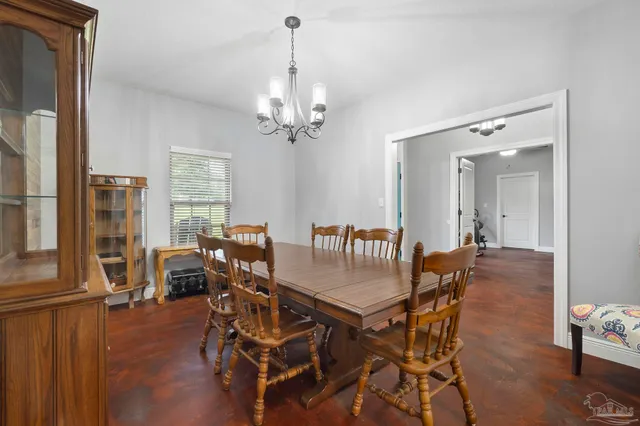 a kitchen with stainless steel appliances granite countertop a stove top oven a sink dishwasher and white cabinets with wooden floor