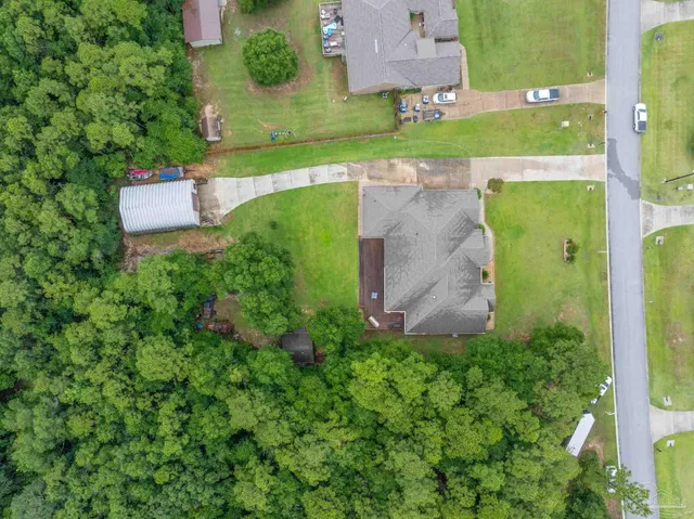 an aerial view of a house with a garden and a yard