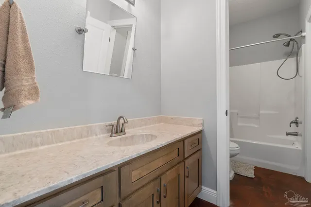 a bathroom with a shower and a glass door