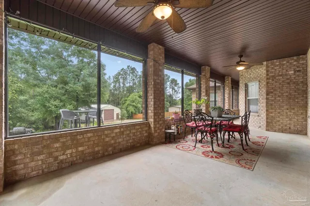 an aerial view of a house with swimming pool and garden