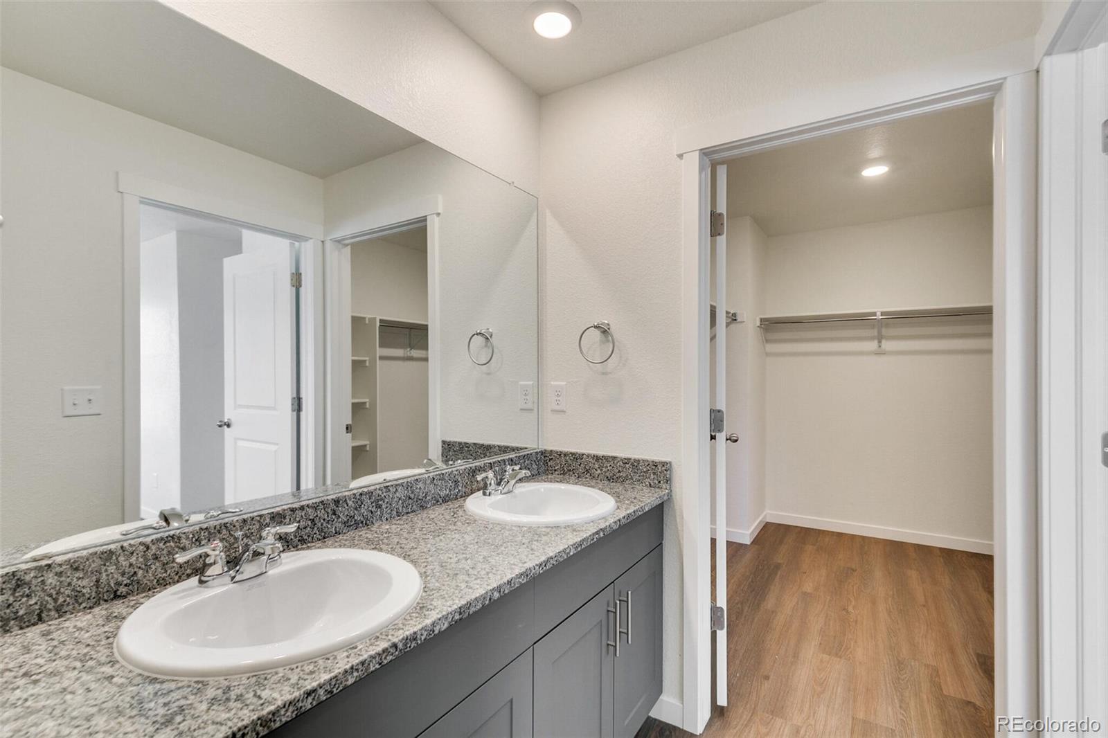 6907 Zig Place Frederick, CO 80530 - Photo 20 of 36 a bathroom with a sink double vanity and a mirror