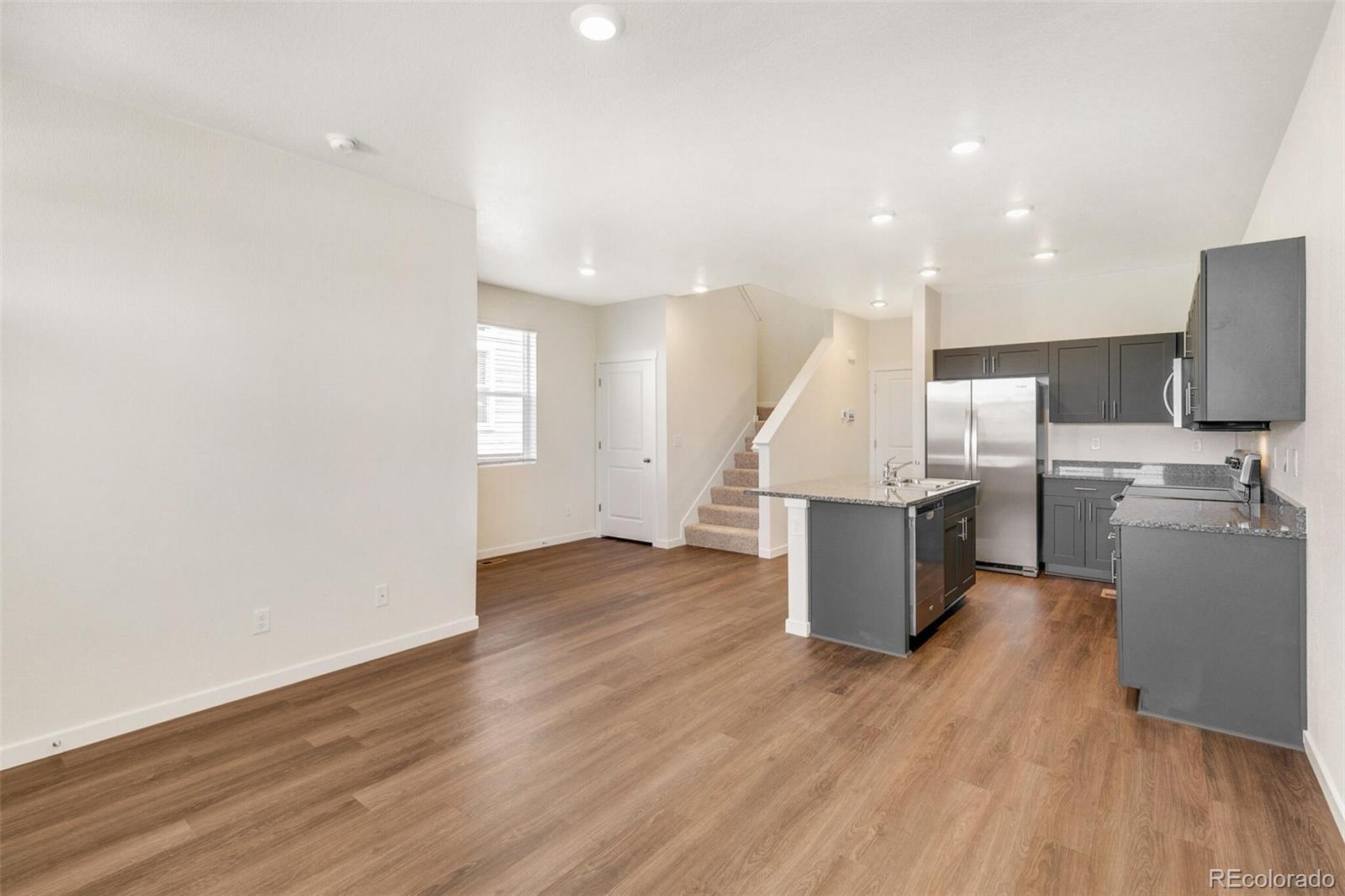 6907 Zig Place Frederick, CO 80530 - Photo 4 of 36 a view of kitchen with furniture and wooden floor