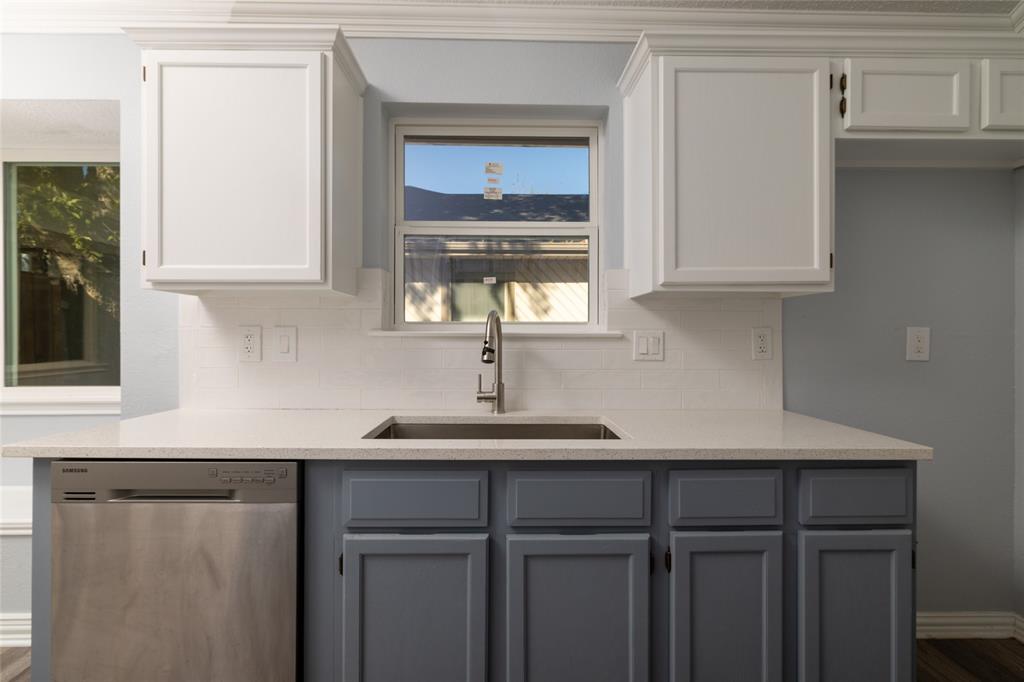 2513 Poplar Spring Road Fort Worth, TX 76123 - Photo 20 of 40 Dual-toned cabinetry, stainless steel dishwasher, undermount sink with a chrome faucet, light-toned countertop, and white subway tile backsplash