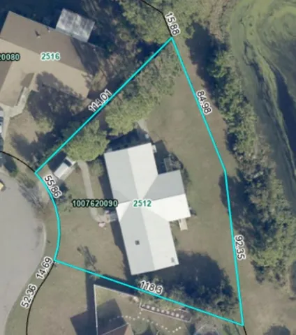 an aerial view of a house with a yard