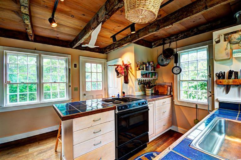 4 Stick Bridge Road Truro, MA 02666 - Photo 11 of 17 a kitchen that has a sink a stove and a table in it