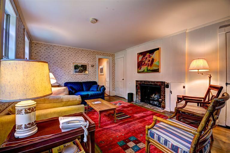 4 Stick Bridge Road Truro, MA 02666 - Photo 8 of 17 a living room with furniture a fireplace and a flat screen tv