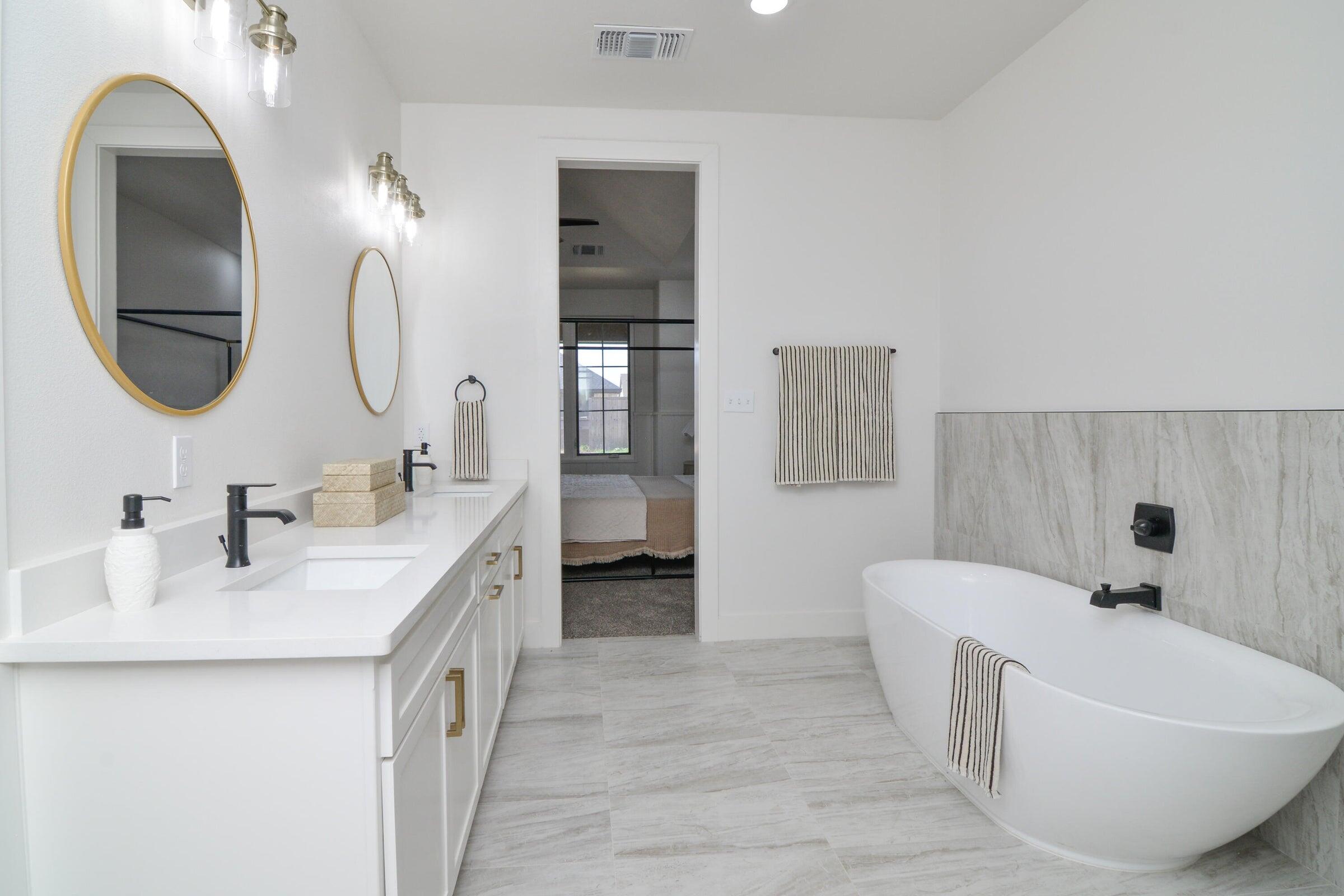 7801 56th Street Lubbock, TX 79407 - Photo 13 of 29 a bathroom with a double vanity sink and a mirror