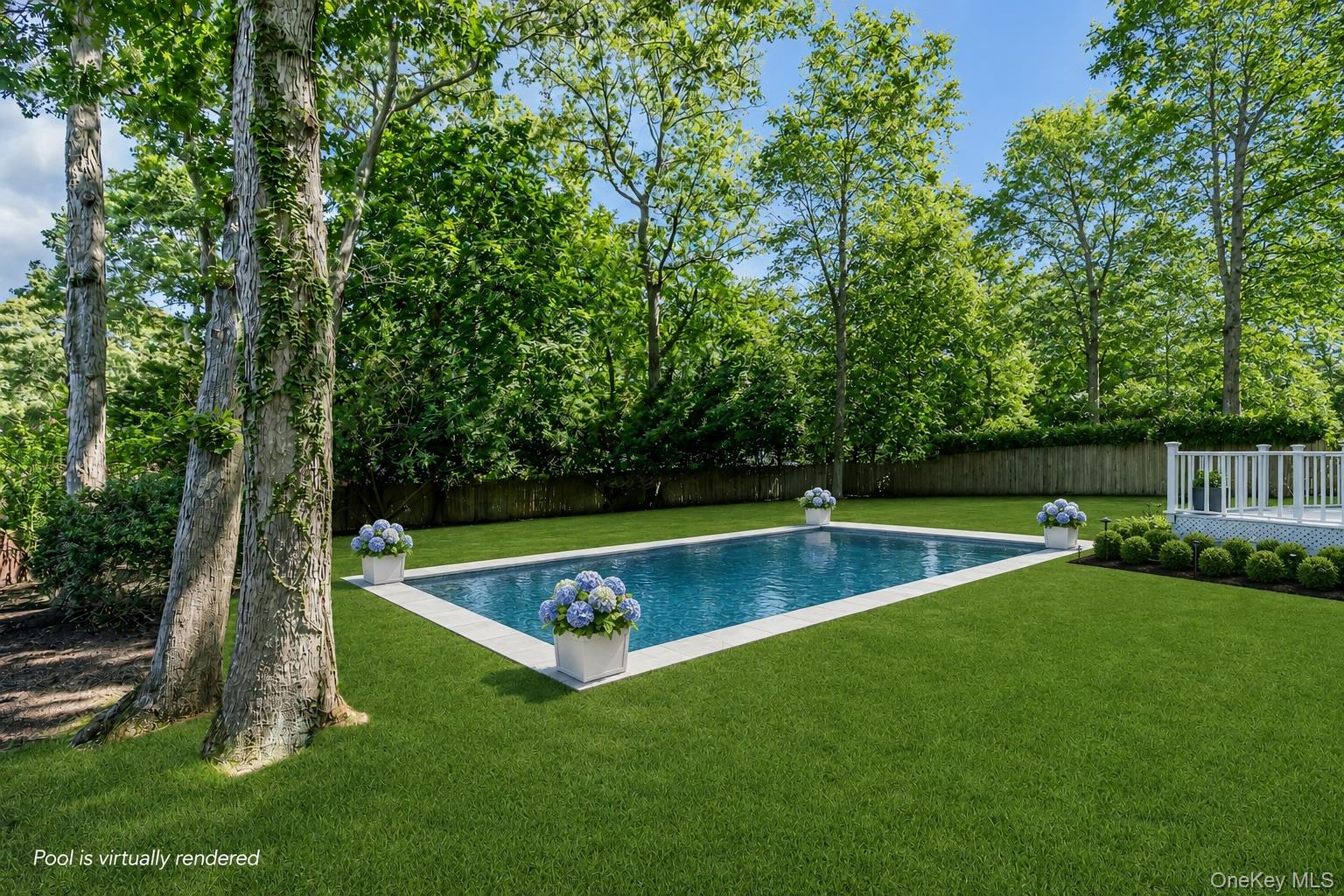 275 Pinewood Road Cutchogue, NY 11935 - Photo 36 of 45 Expansive backyard featuring a rectangular swimming pool with white coping, a surrounding manicured lawn, a white deck with railings, and mature trees providing natural screening