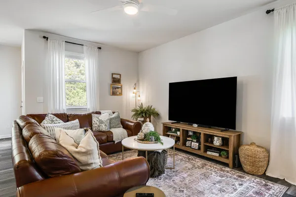 a living room with furniture and a flat screen tv