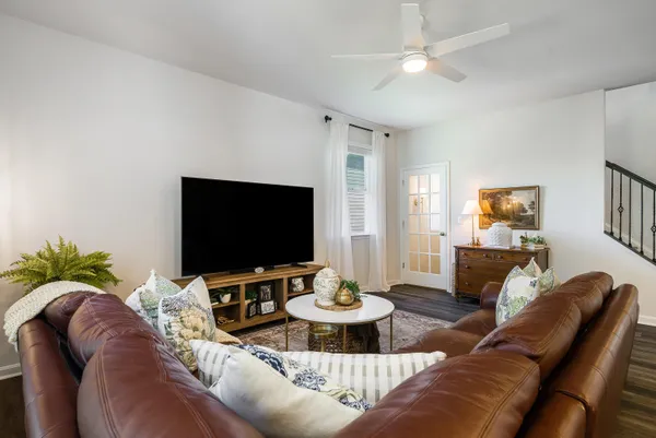 a living room with furniture and a view of kitchen