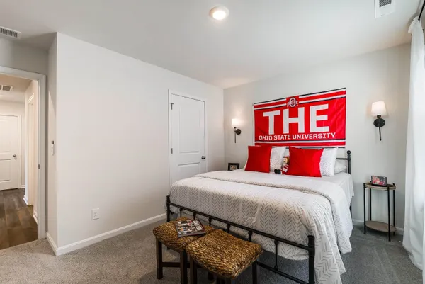a bedroom with a bed and a mirror
