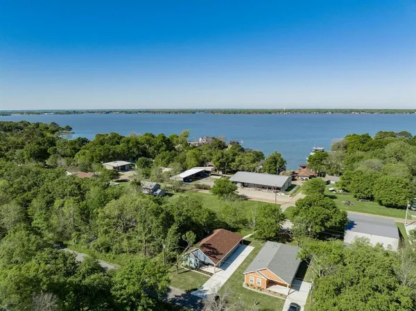 an aerial view of a residential houses with city view