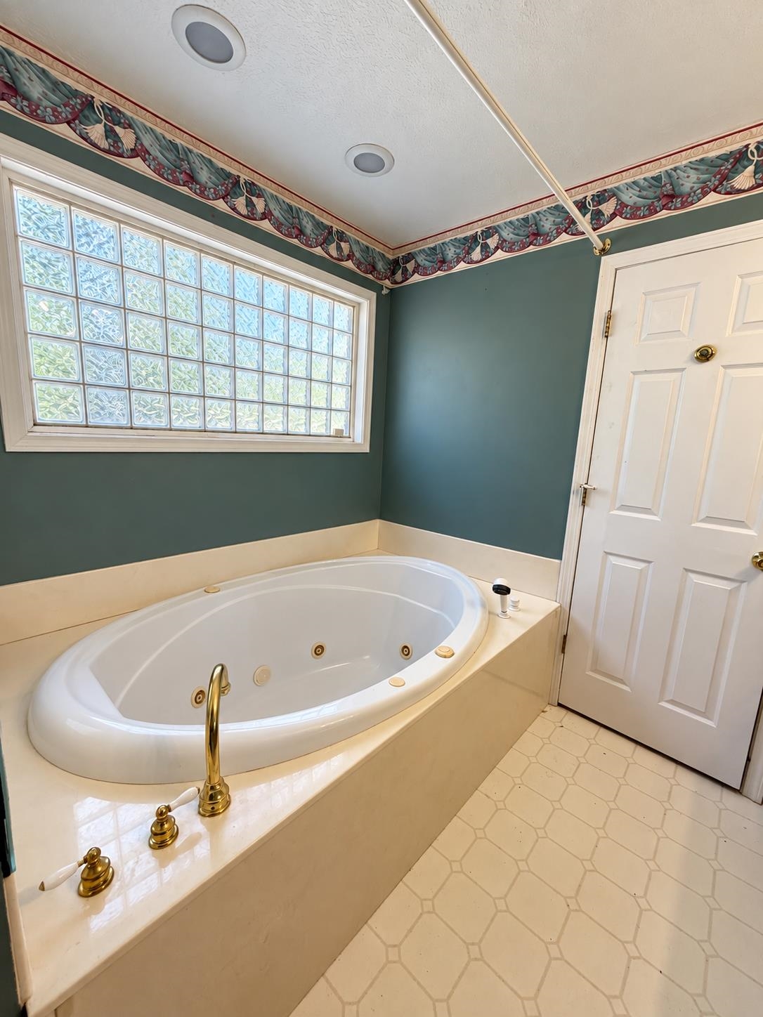 741 Dancer Road Selmer, TN 38375 - Photo 18 of 30 Oval soaking tub with brass fixtures, a glass block window.