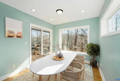 a view of an empty room with a window and fireplace
